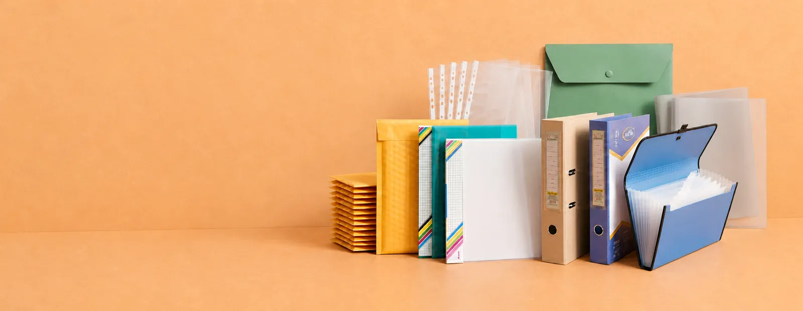 Aarpee stationery products arranged on the right against a terracotta studio background
