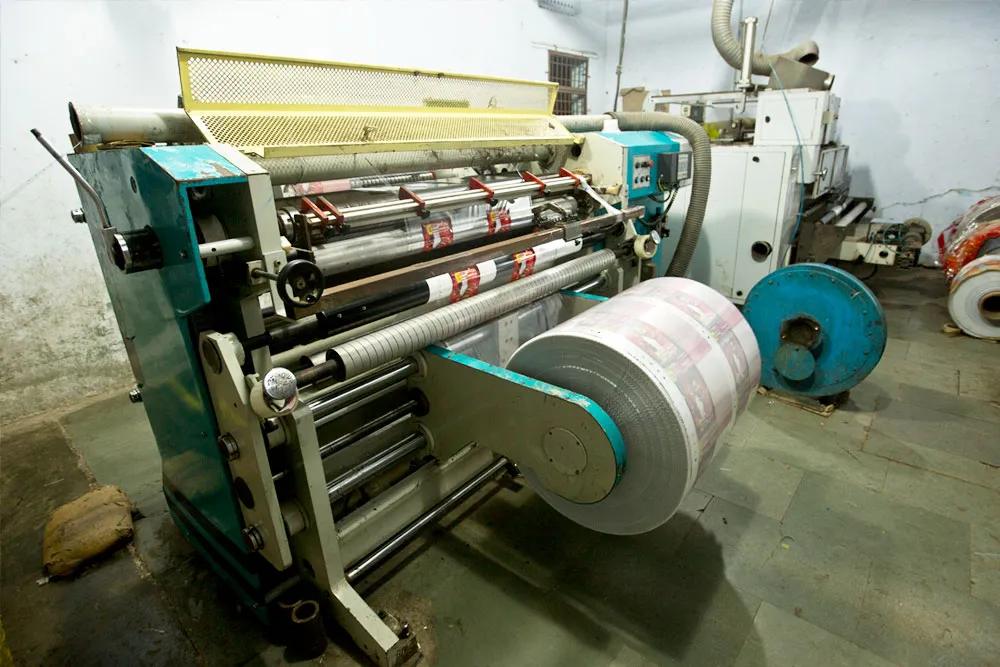 Slitting and rewinding machine loaded with a large roll of printed film